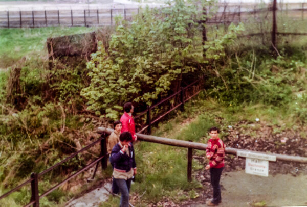 Four schoolboys facing the Iron Curtain.